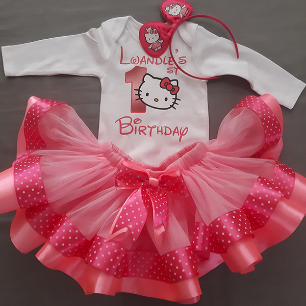Product: Hello kitty pink ribbon tutu with a personalised top and hairband